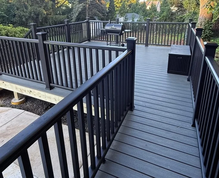 Long dark gray composite deck with black aluminum railings
